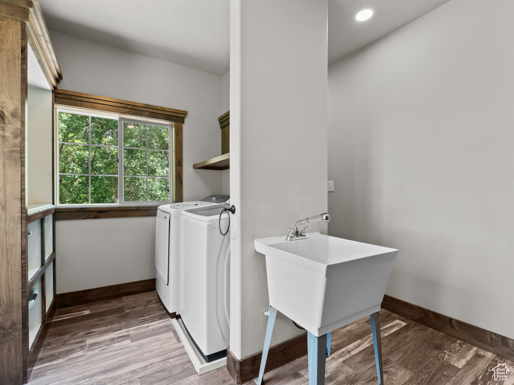 Laundry area with washer and dryer, baseboards, light wood-style flooring, and recessed lighting