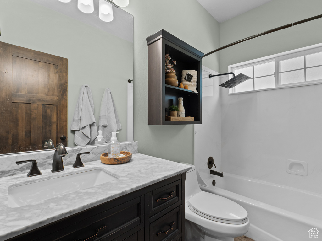 Bathroom with shower / tub combination, vanity, and toilet