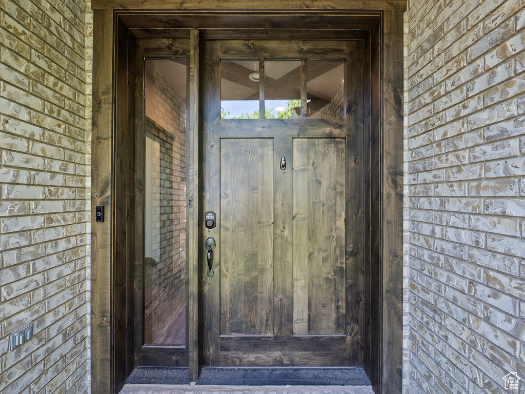 Doorway to property with brick siding