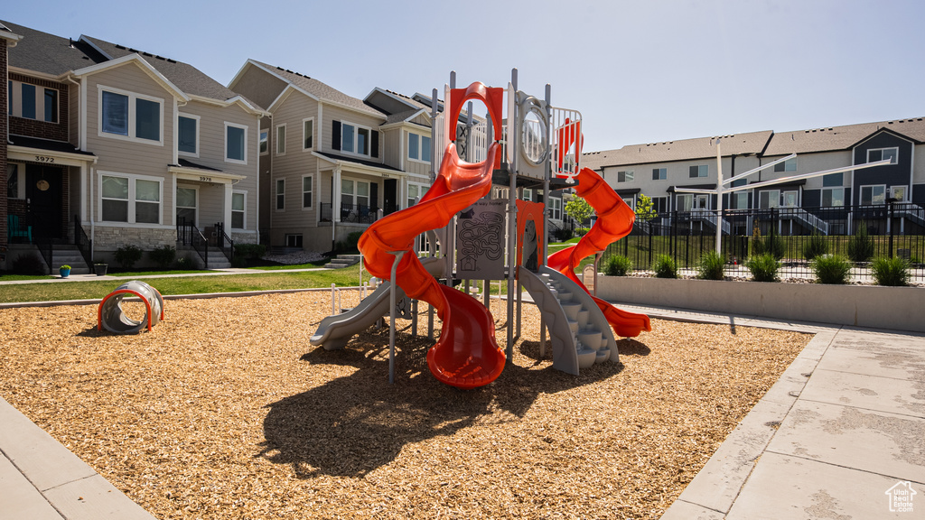 Communal playground with a residential view and fence