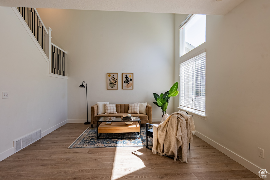 Living area with wood finished floors and baseboards