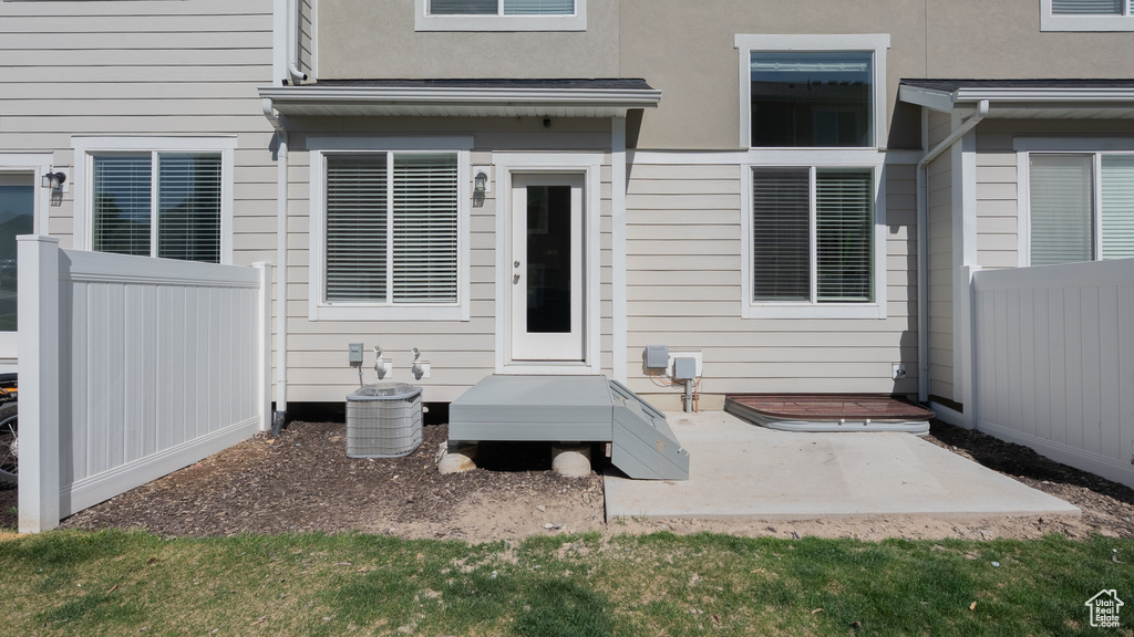 Entrance to property featuring fence, a patio area, and stucco siding