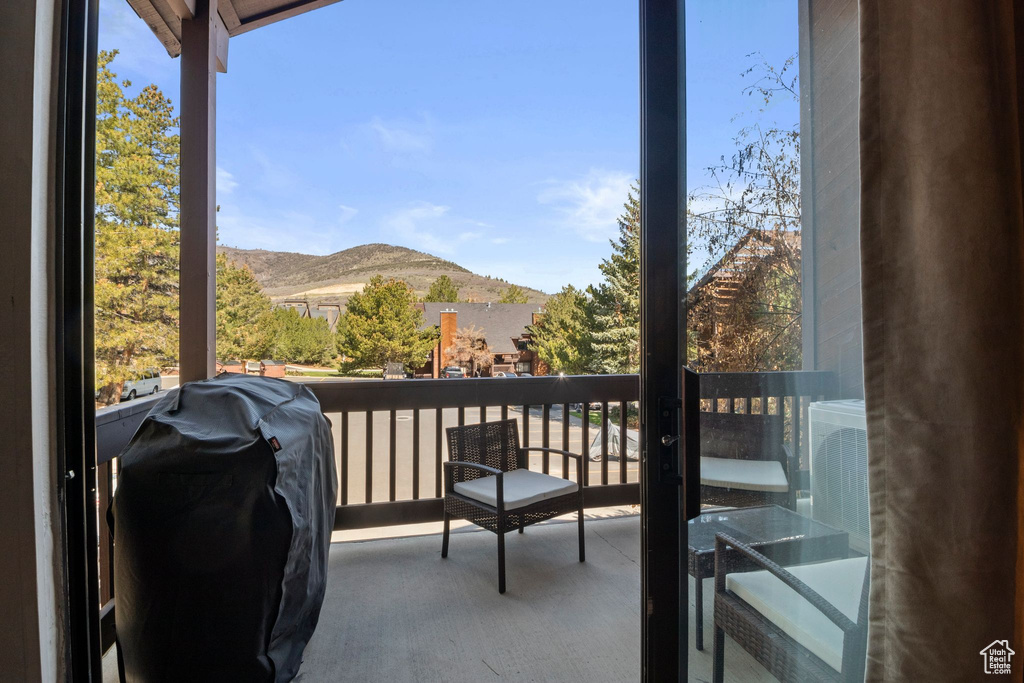 Balcony featuring a mountain view and a grill