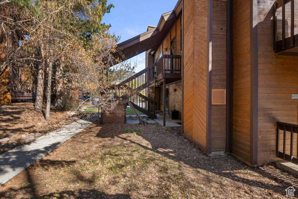 View of side of home featuring stairs