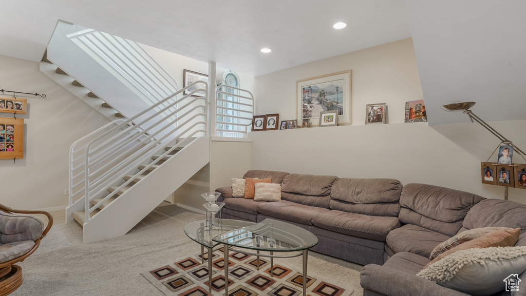 Carpeted living room featuring stairway, recessed lighting, and baseboards