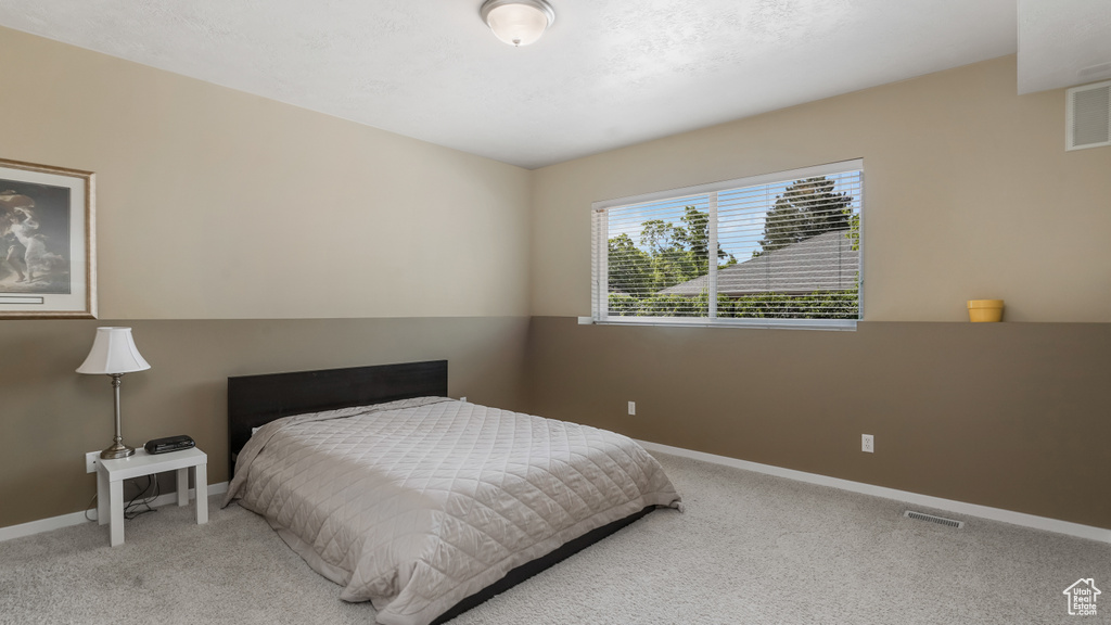 Bedroom featuring carpet floors and baseboards