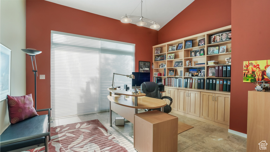 Home office featuring vaulted ceiling