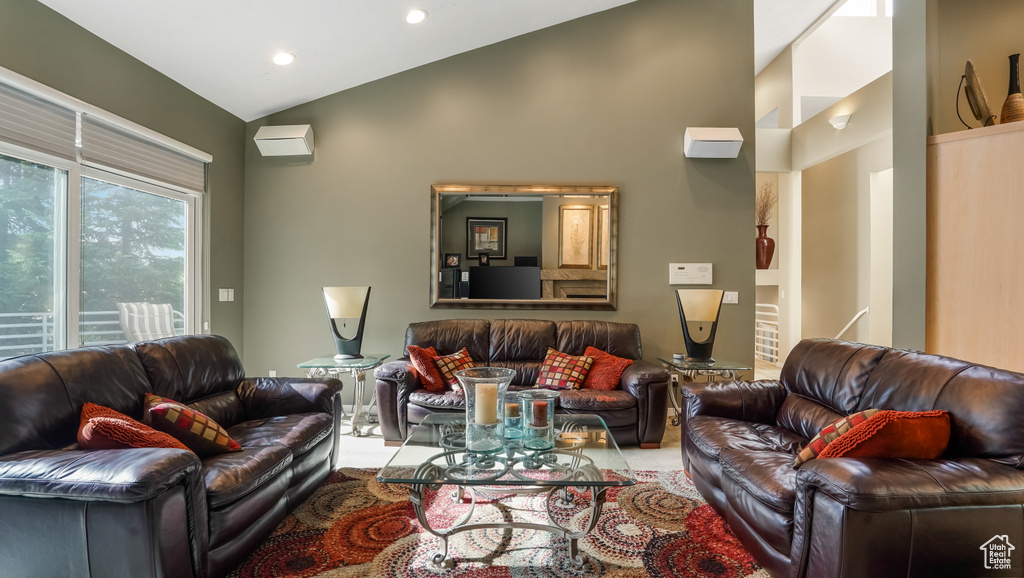 Living area featuring vaulted ceiling and recessed lighting