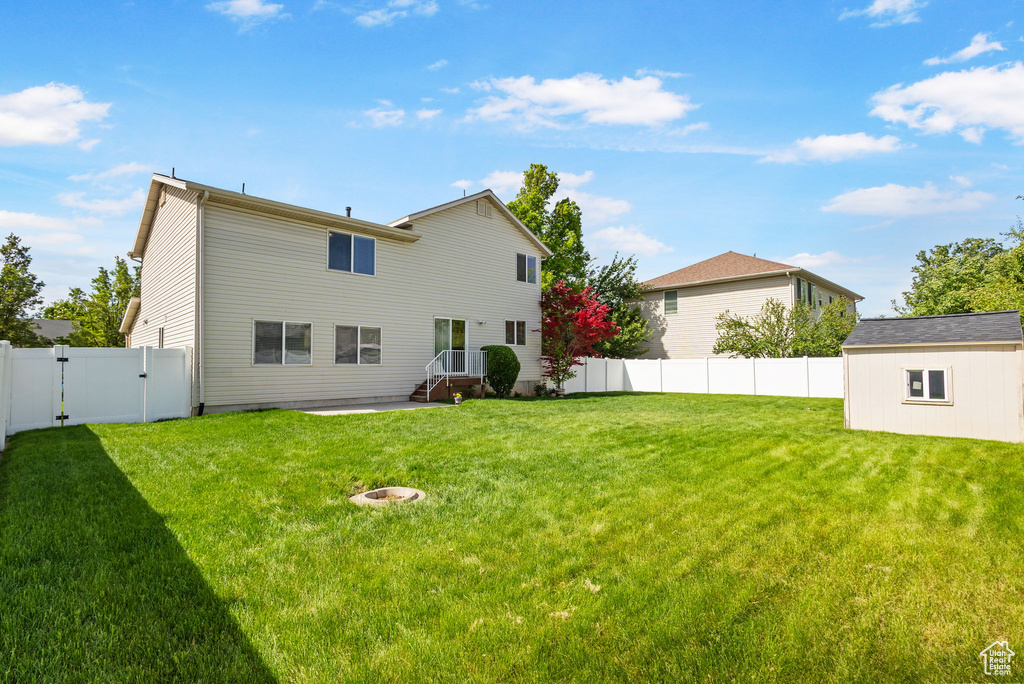 Rear view of property featuring a gate and a patio