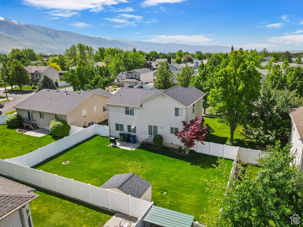Aerial perspective of suburban area with a mountainous background