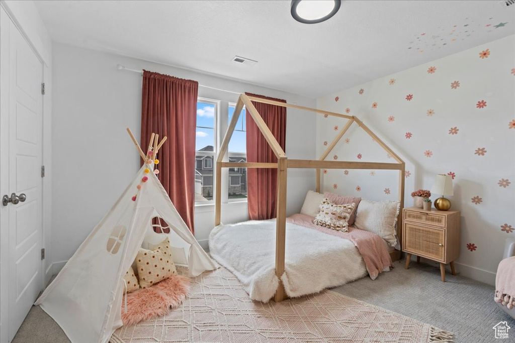 Carpeted bedroom featuring wallpapered walls and baseboards