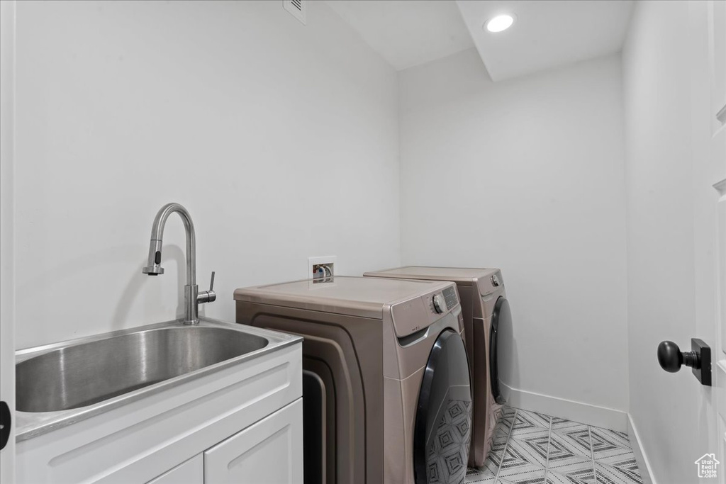 Laundry room with independent washer and dryer, cabinet space, and baseboards