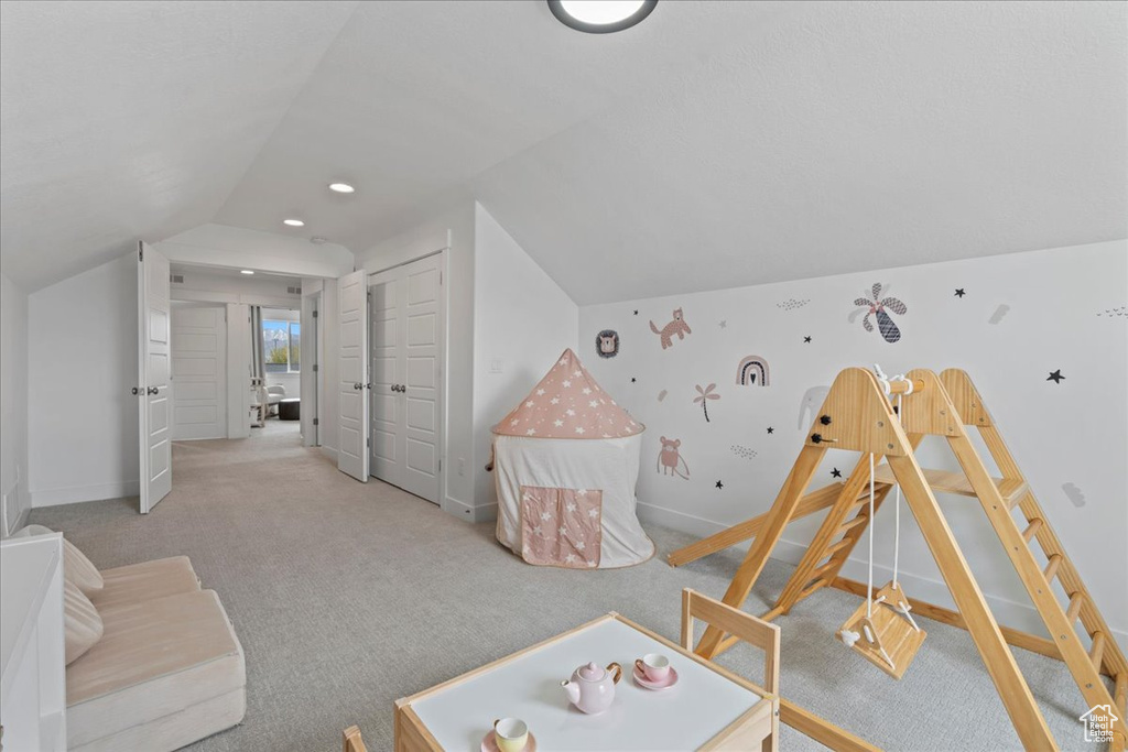 Game room with baseboards, lofted ceiling, and carpet flooring
