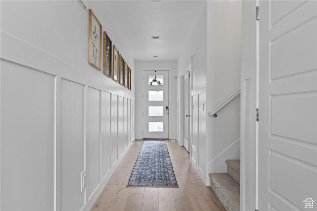 Entryway with light wood-style floors and stairway
