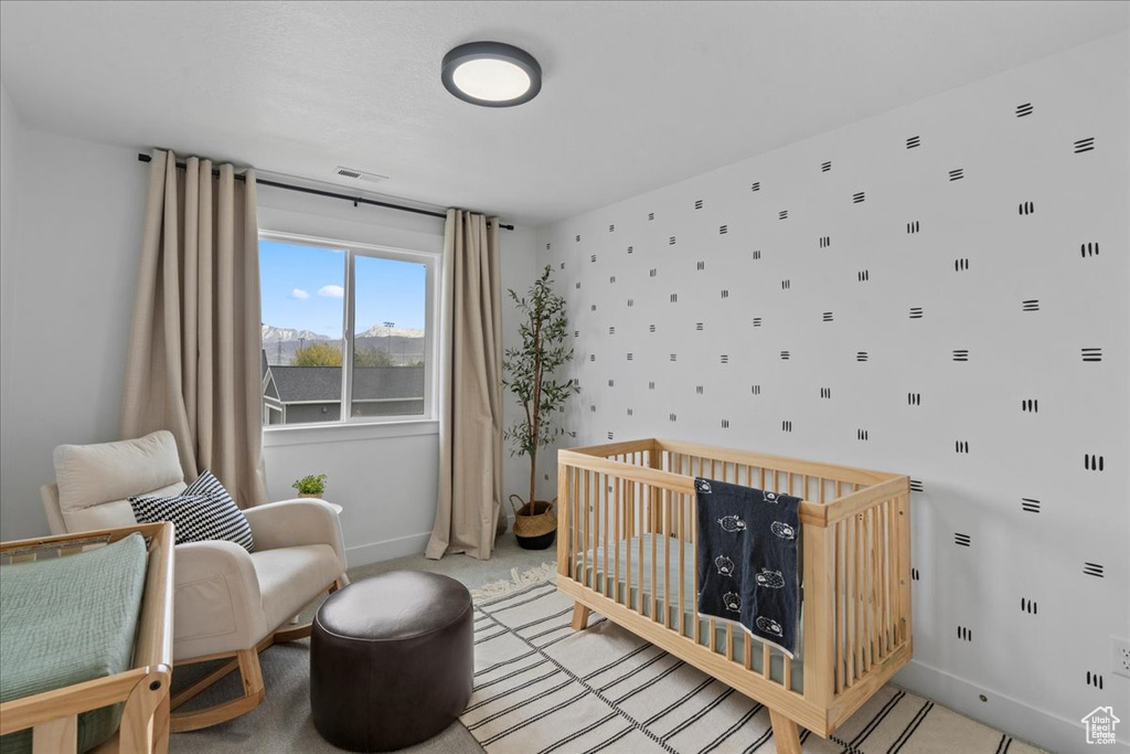 Bedroom with baseboards and a nursery area