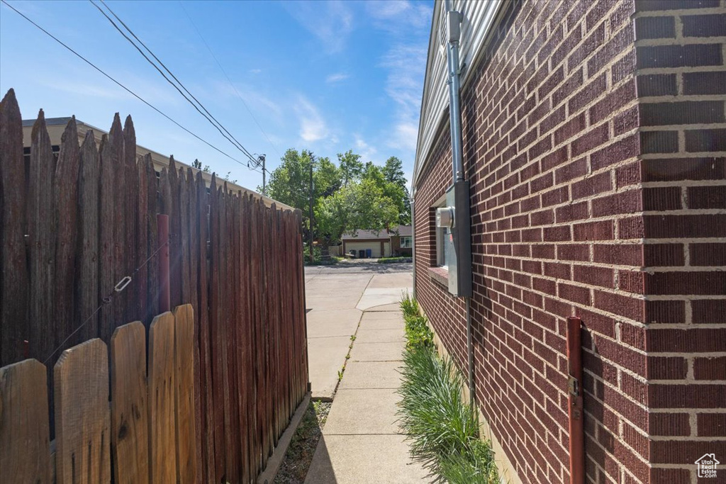 View of home's exterior with fence and brick siding