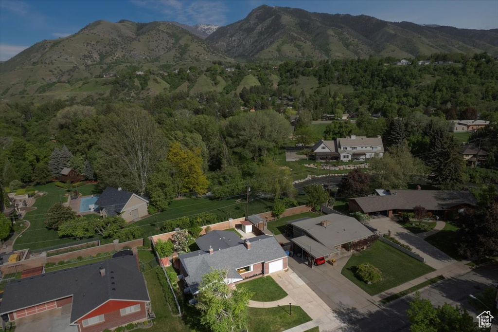 Aerial overview of property's location with a mountainous background and nearby suburban area