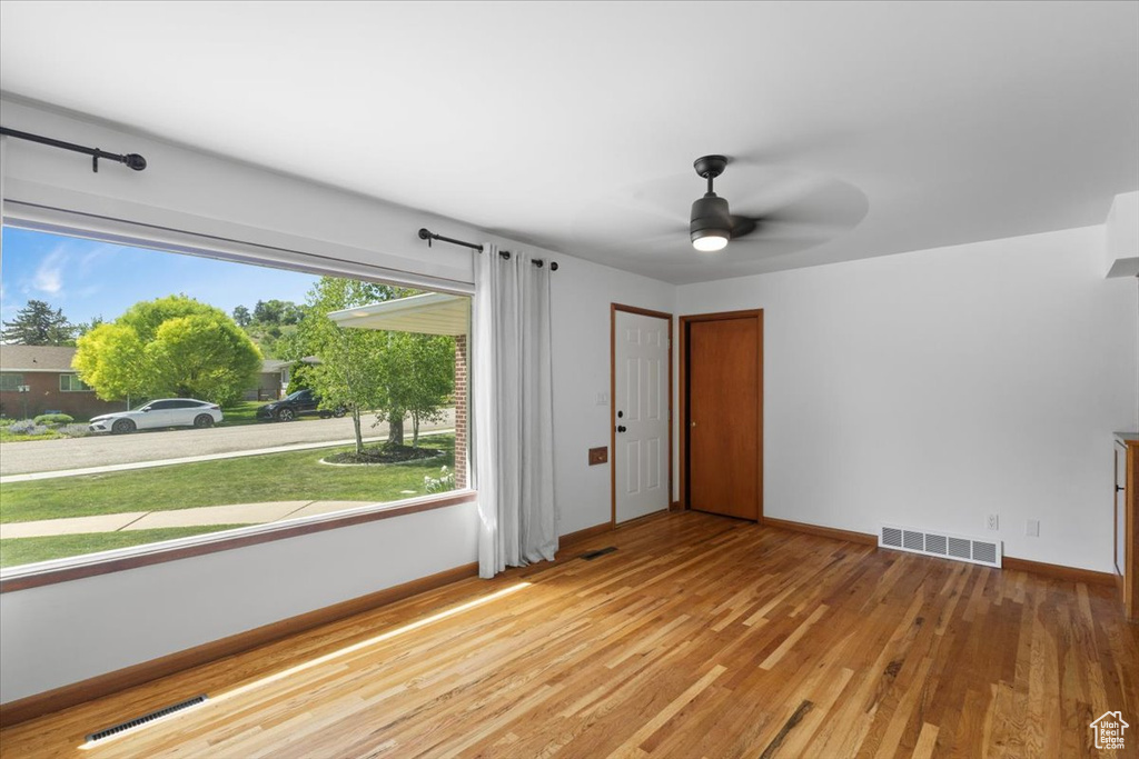 Foyer entrance featuring light wood-style floors, ceiling fan, and baseboards