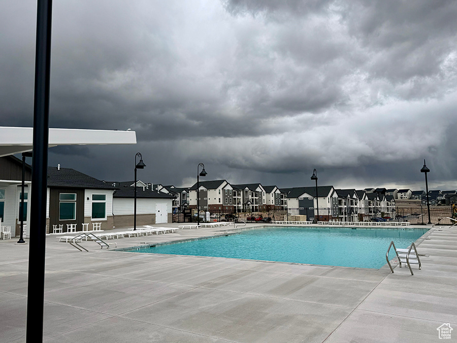 Community pool featuring a residential view and a patio