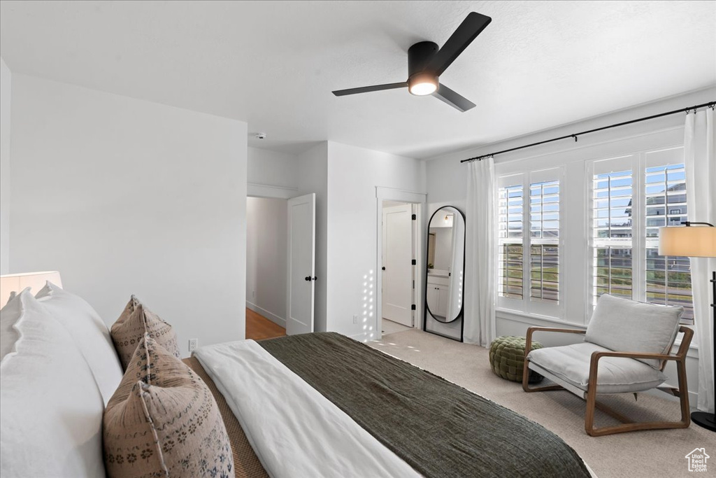 Carpeted bedroom featuring ceiling fan