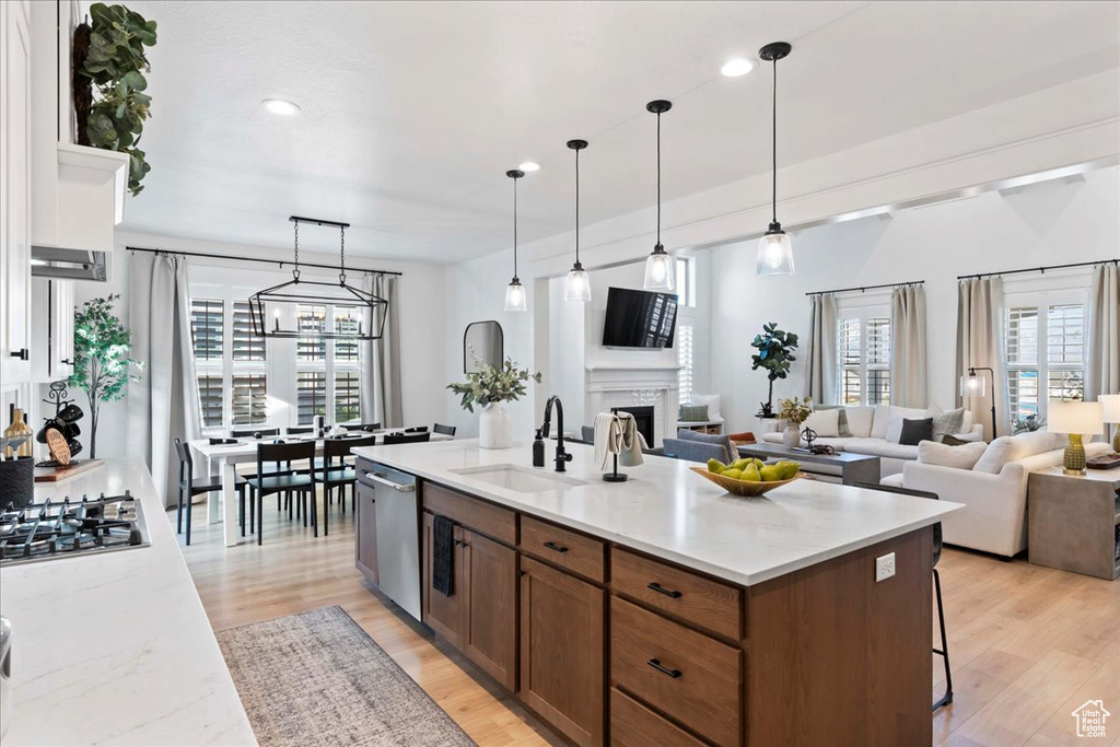Kitchen with a sink, stainless steel appliances, open floor plan, plenty of natural light, and recessed lighting