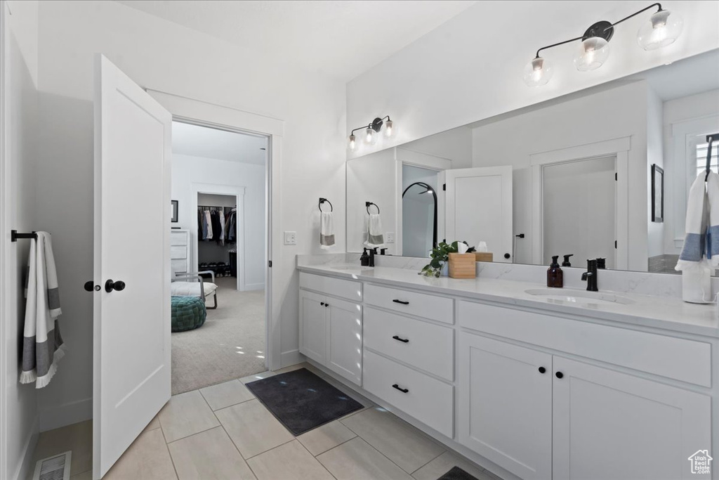 Full bath with double vanity and tile patterned floors