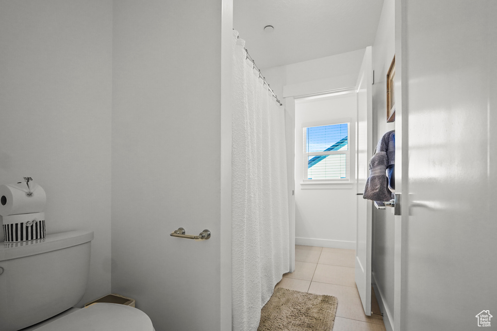 Bathroom with tile patterned flooring and toilet