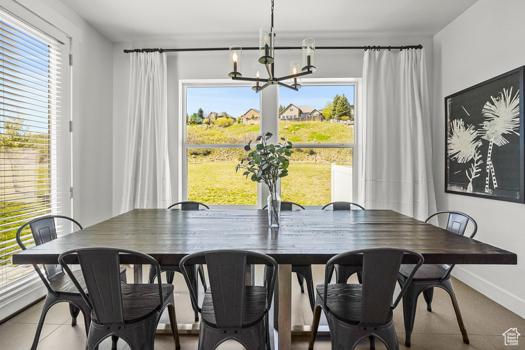 Dining area featuring a chandelier and baseboards