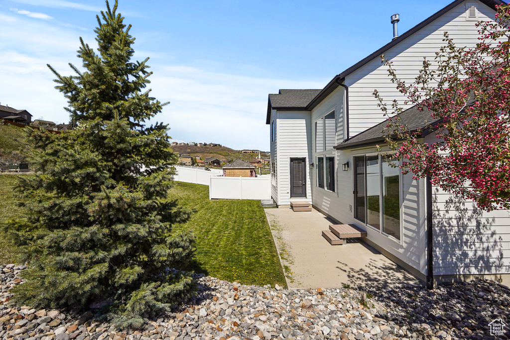 View of yard featuring a patio area and entry steps