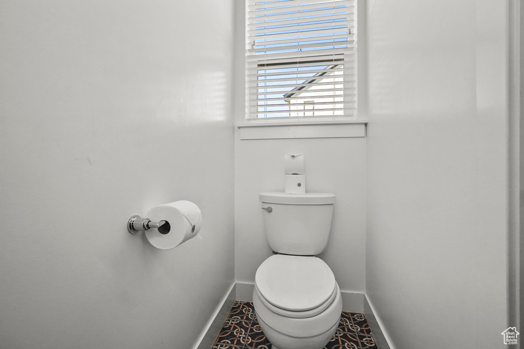 Bathroom with baseboards and toilet