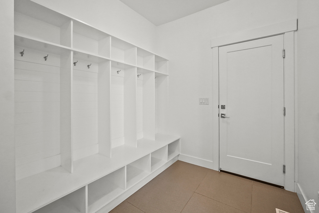 Mudroom featuring tile patterned flooring and baseboards