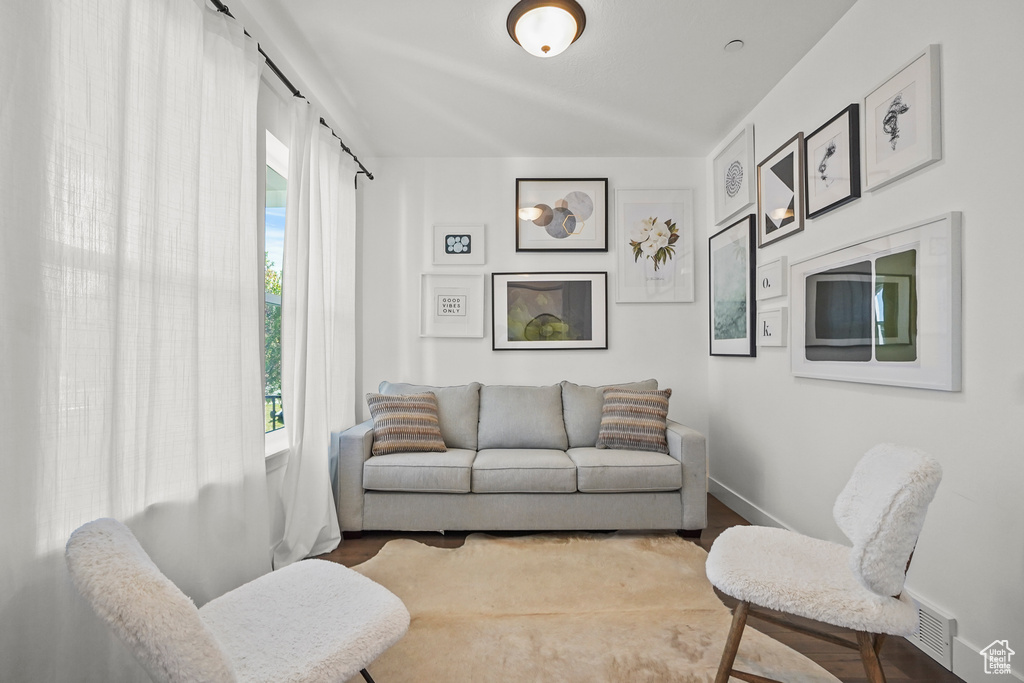 Living area with baseboards and wood finished floors