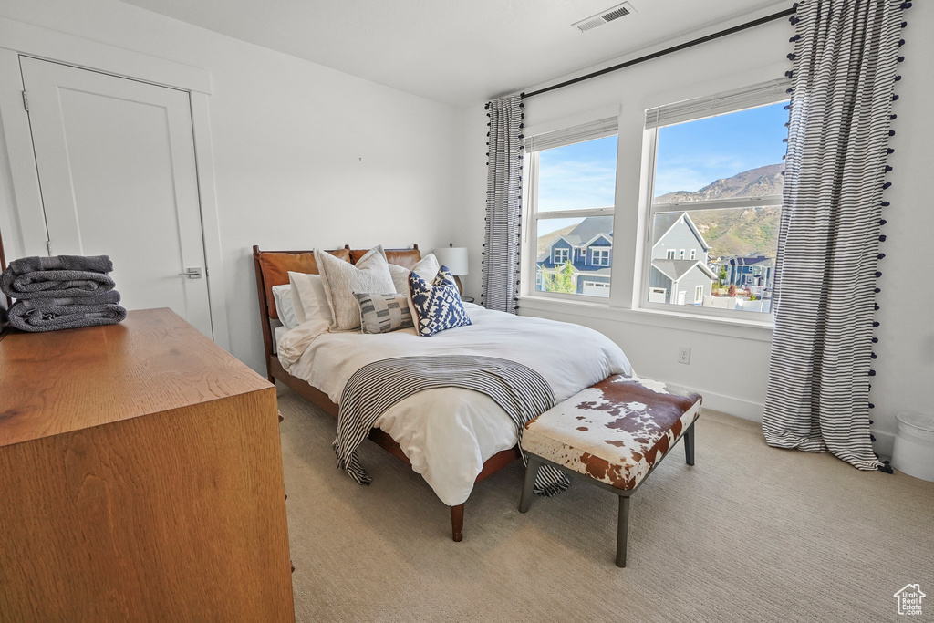 Bedroom featuring carpet floors and baseboards