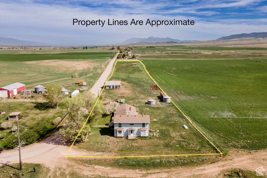 Overview of rural landscape with property boundaries highlighted and a mountainous background