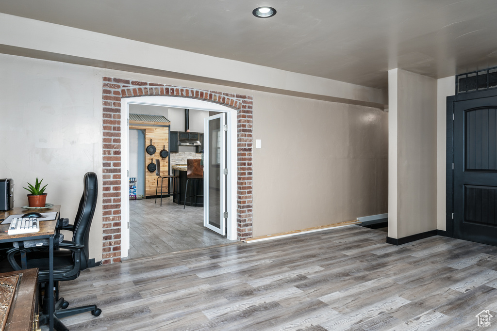 Home office featuring wood finished floors and baseboards