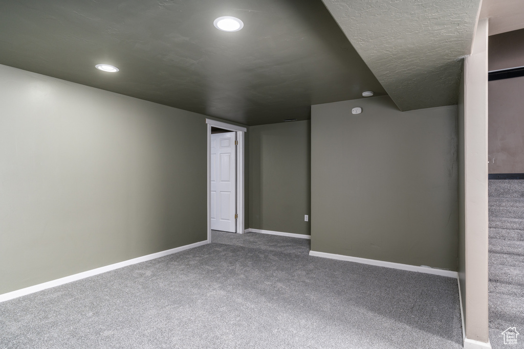 Carpeted empty room featuring baseboards and recessed lighting