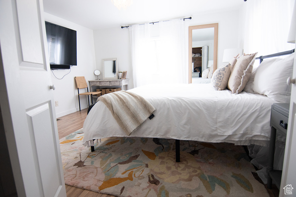 Bedroom featuring wood finished floors and baseboards