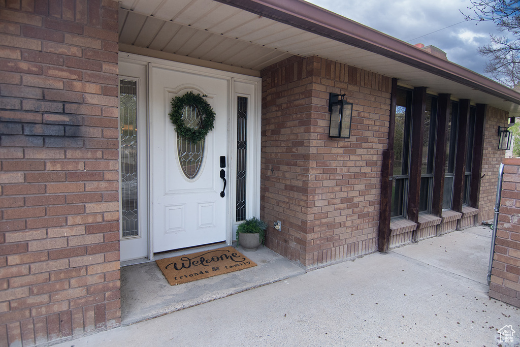 View of exterior entry with brick siding