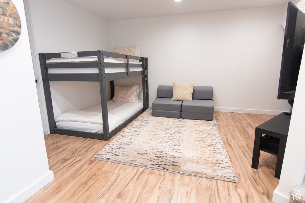 Bedroom featuring wood finished floors and baseboards