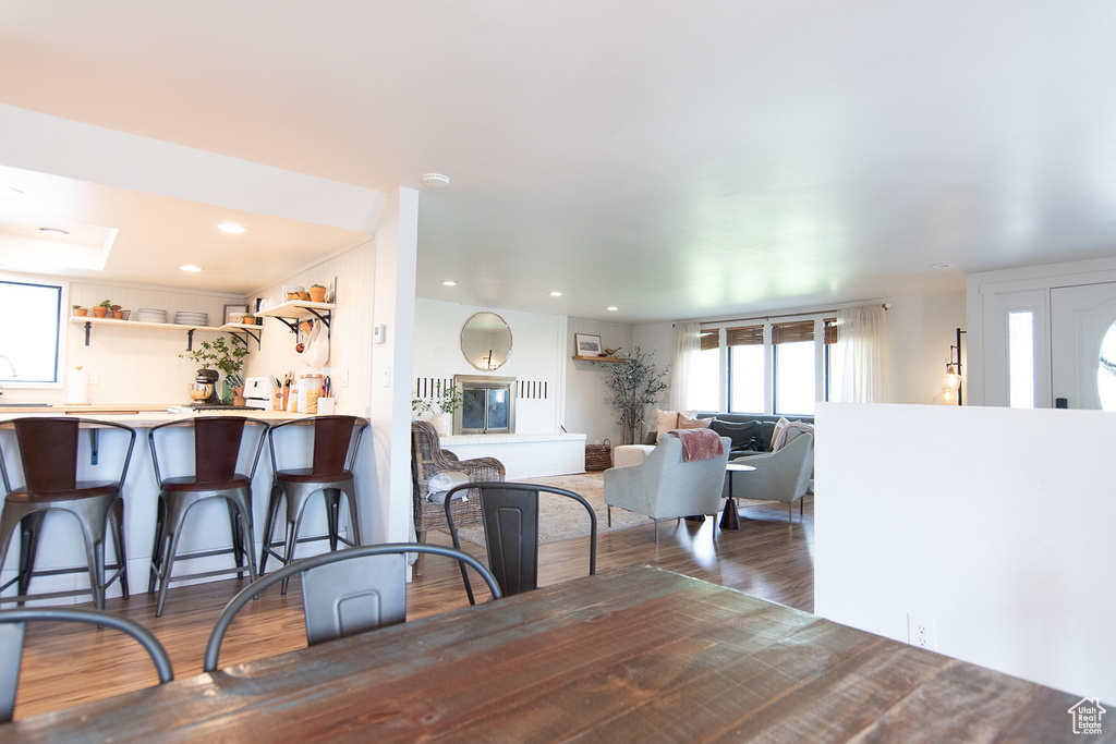 Dining area with wood finished floors and recessed lighting