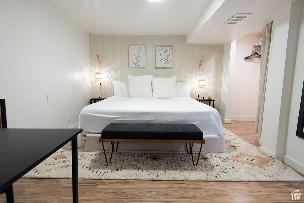 Bedroom with wood finished floors and baseboards