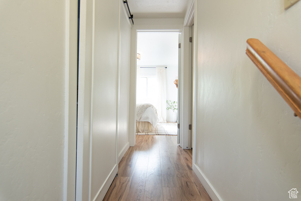 Hall featuring wood finished floors and baseboards