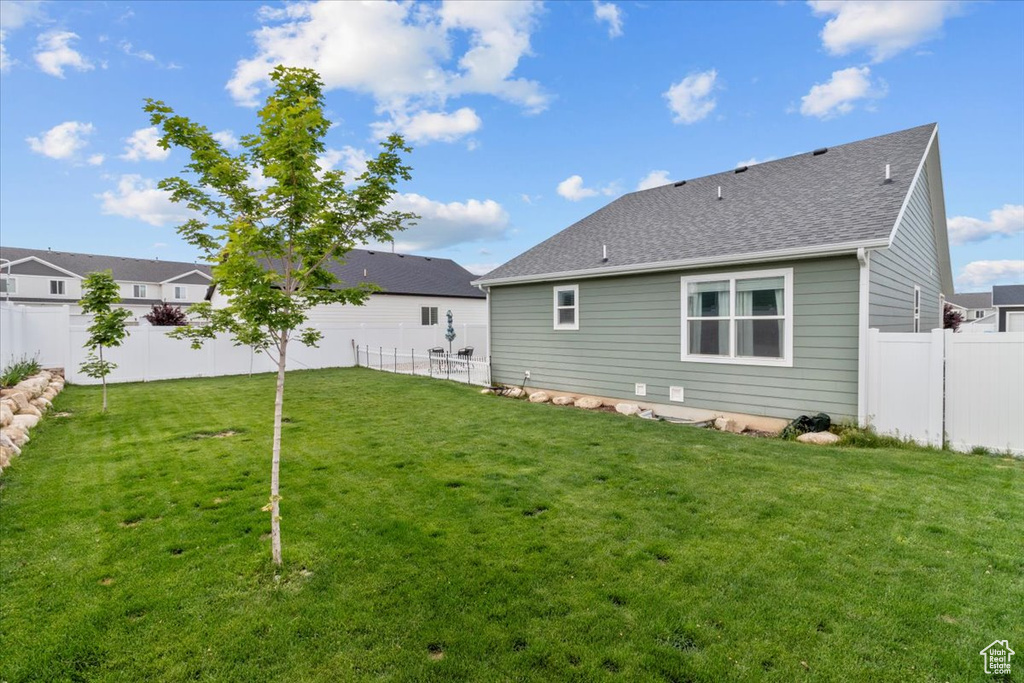 Back of property featuring a shingled roof