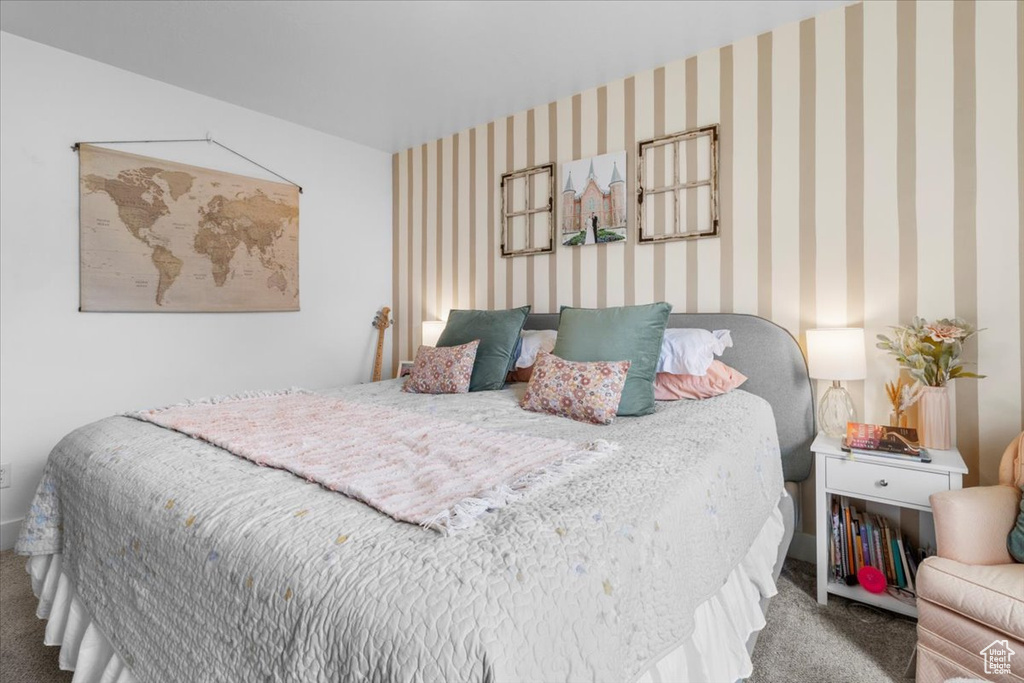 Bedroom featuring carpet floors and wallpapered walls