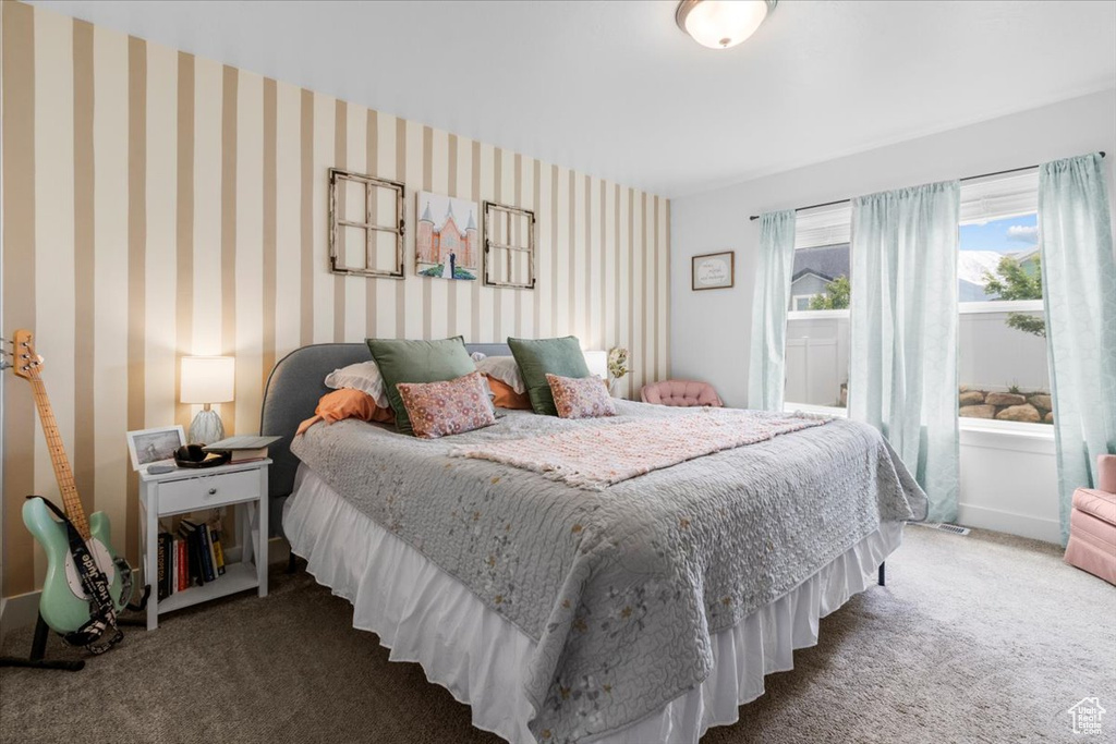 Carpeted bedroom featuring wallpapered walls