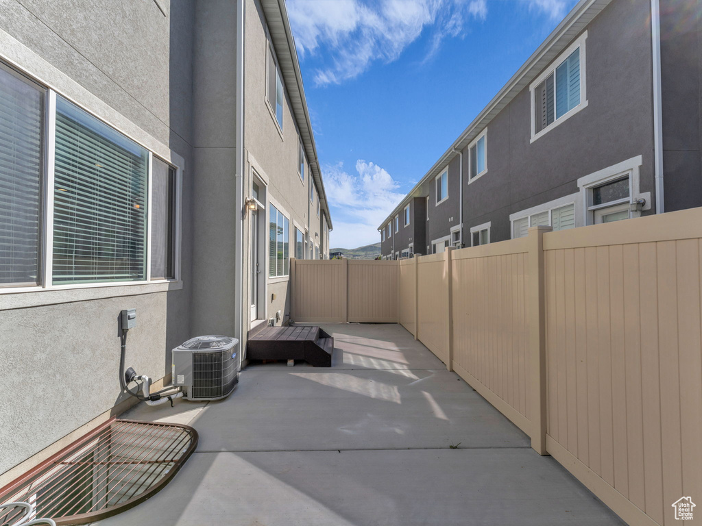 View of patio / terrace with central AC unit and fence