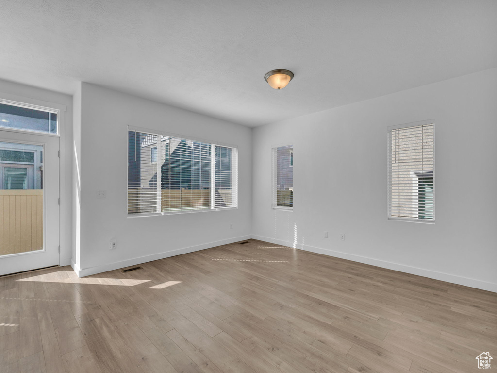 Spare room featuring wood finished floors and baseboards