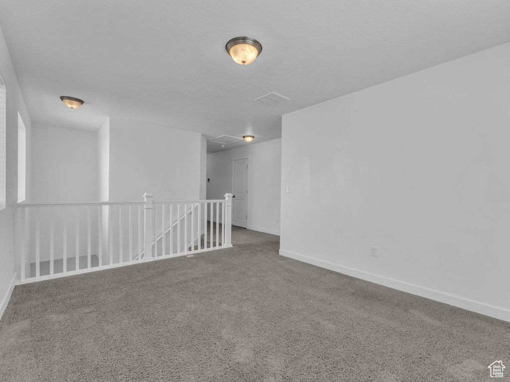 Carpeted empty room with baseboards