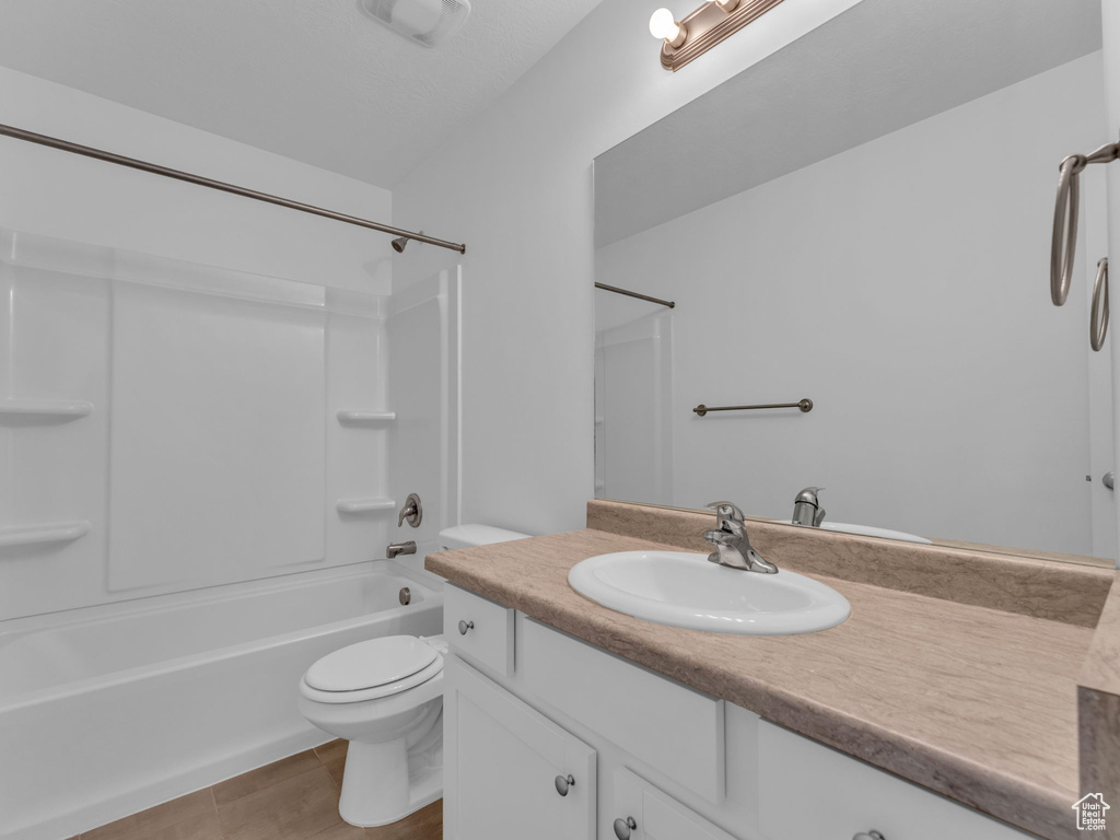 Full bathroom with toilet, vanity, shower / bath combination, and wood finished floors