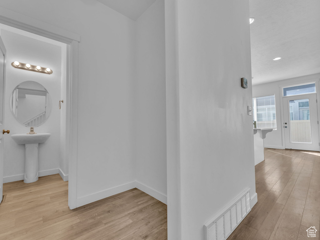 Hall featuring wood finished floors and baseboards